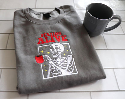 EMBROIDERED SWEATSHIRT- STAYING ALIVE COFFEE AND SKELETON